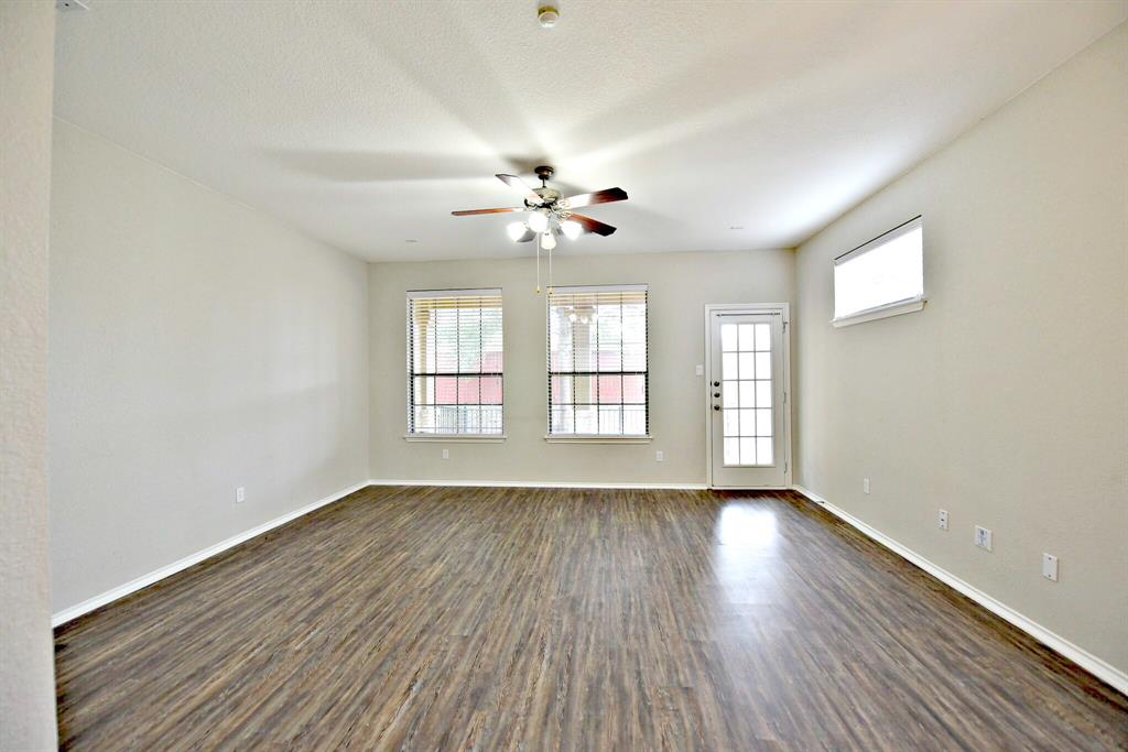 14815 Avery Ranch Boulevard, Unit 702 Austin, TX 78717 - Photo 4 of 19 Empty room with baseboards, a ceiling fan, and dark wood-style floors