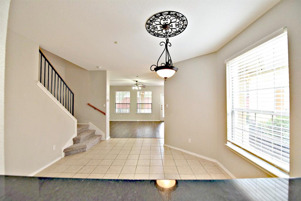 14815 Avery Ranch Boulevard, Unit 702 Austin, TX 78717 - Photo 9 of 19 Foyer entrance with stairway, baseboards, a ceiling fan, and tile patterned flooring