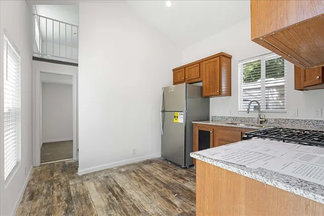 a kitchen with a sink a refrigerator and a stove