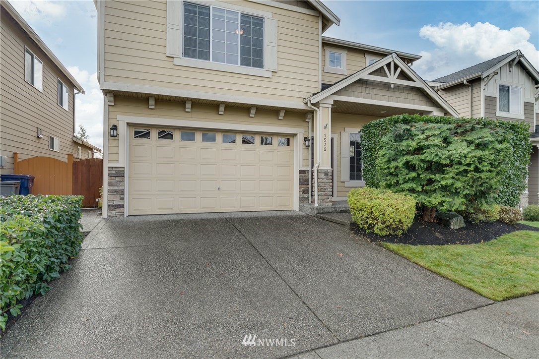 1532 170th Street Southeast Bothell, WA 98012 - Photo 2 of 39 a front view of a house with a yard and garage