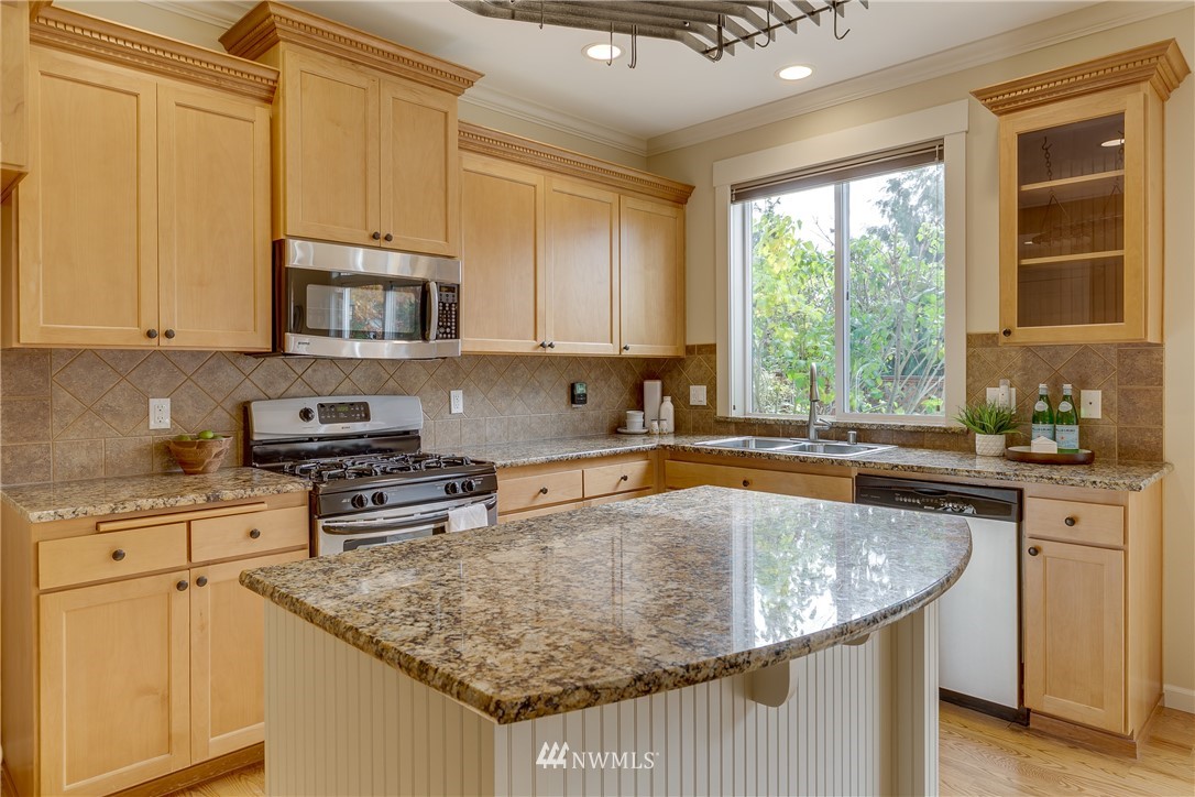 1532 170th Street Southeast Bothell, WA 98012 - Photo 16 of 39 a kitchen with stainless steel appliances granite countertop a sink stove and microwave