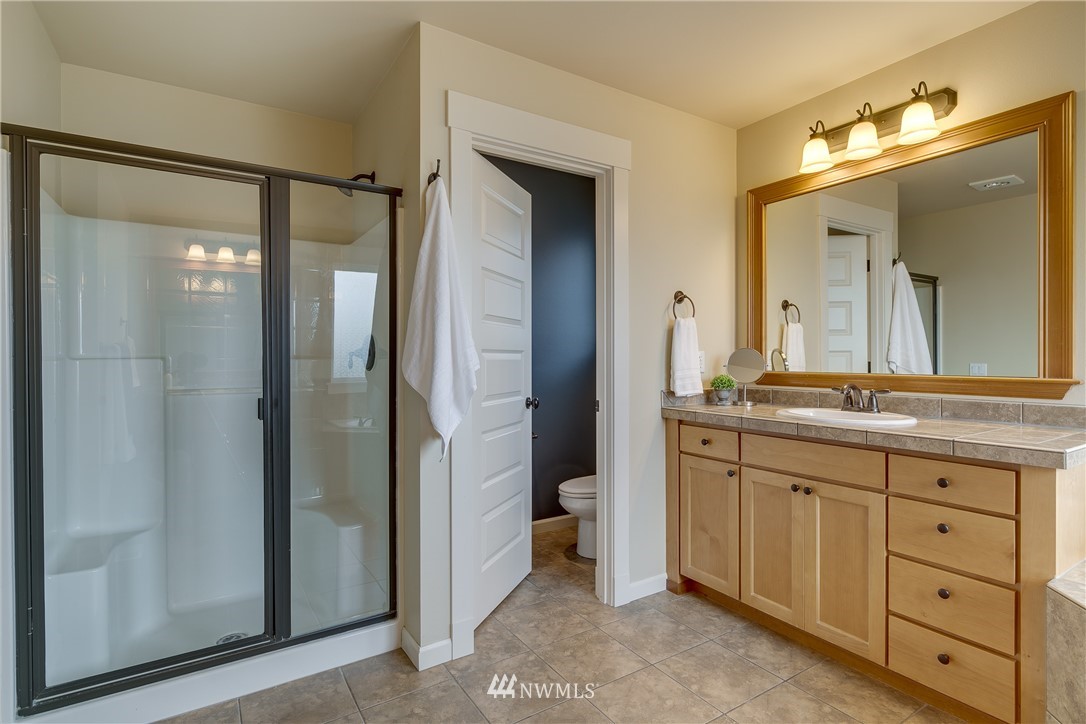 1532 170th Street Southeast Bothell, WA 98012 - Photo 24 of 39 a spacious bathroom with a granite countertop sink mirror and shower