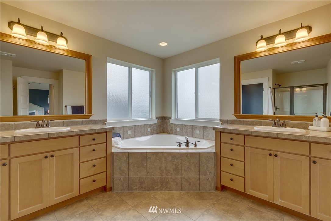 1532 170th Street Southeast Bothell, WA 98012 - Photo 25 of 39 a spacious bathroom with a double vanity sink mirror and bathtub