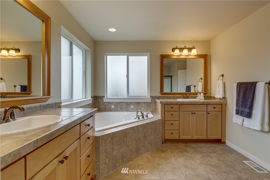 1532 170th Street Southeast Bothell, WA 98012 - Photo 26 of 39 a spacious bathroom with a double vanity sink mirror and bathtub