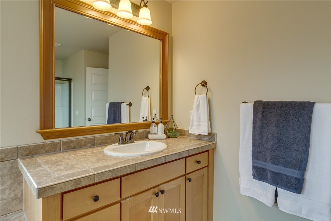 1532 170th Street Southeast Bothell, WA 98012 - Photo 27 of 39 a bathroom with a granite countertop sink and a mirror