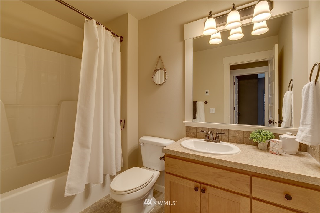 1532 170th Street Southeast Bothell, WA 98012 - Photo 33 of 39 a bathroom with a granite countertop sink toilet and shower