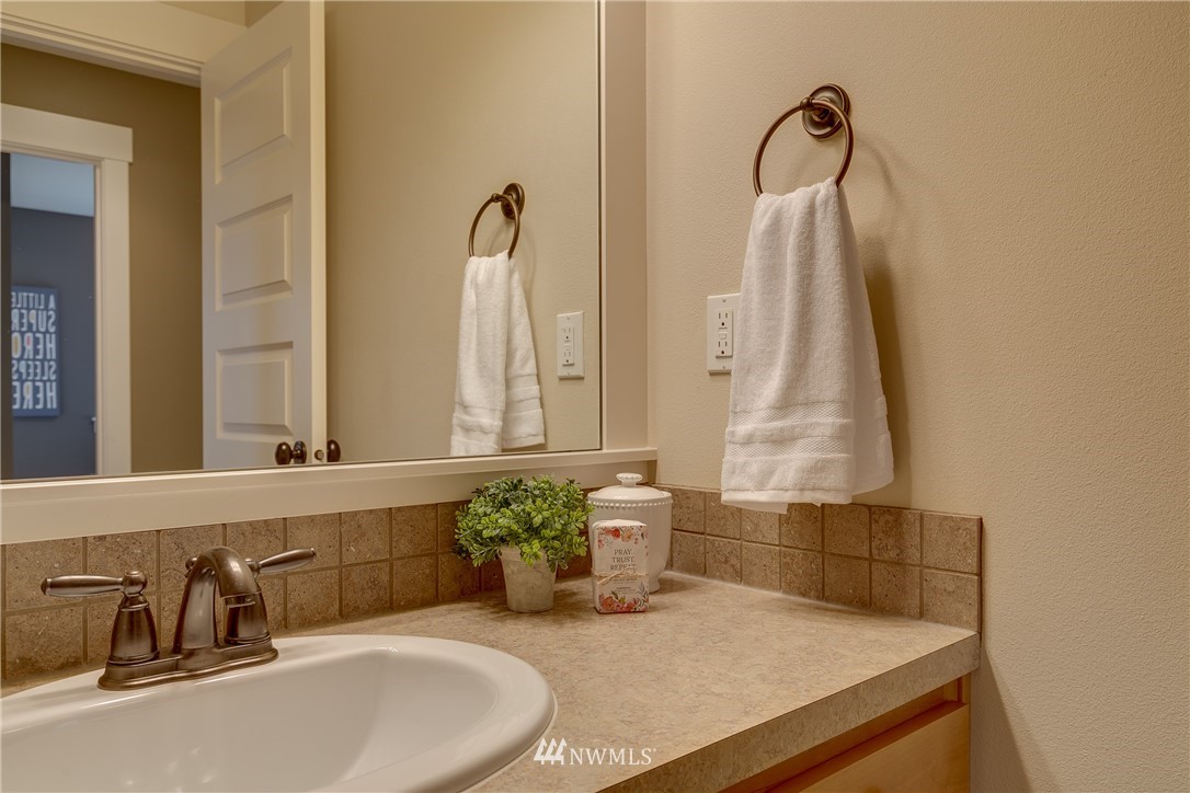 1532 170th Street Southeast Bothell, WA 98012 - Photo 34 of 39 a bathroom with a granite countertop sink and a mirror