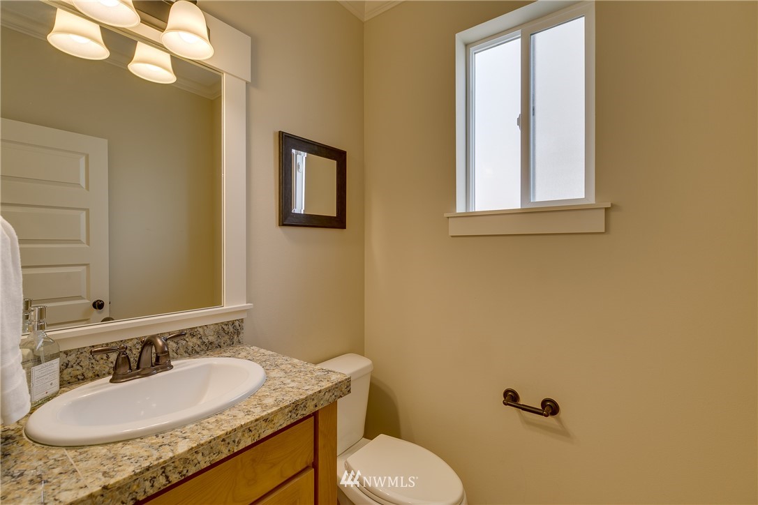 1532 170th Street Southeast Bothell, WA 98012 - Photo 8 of 39 a bathroom with a granite countertop sink mirror vanity and toilet