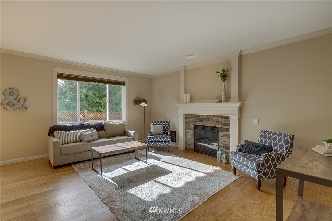 1532 170th Street Southeast Bothell, WA 98012 - Photo 9 of 39 a living room with furniture and a fireplace