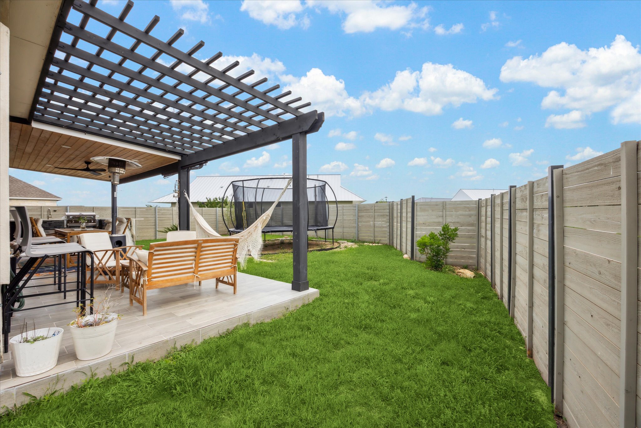 700 Legends Lane Georgetown, TX 78628 - Photo 28 of 31 View of yard featuring a trampoline, a ceiling fan, and a pergola