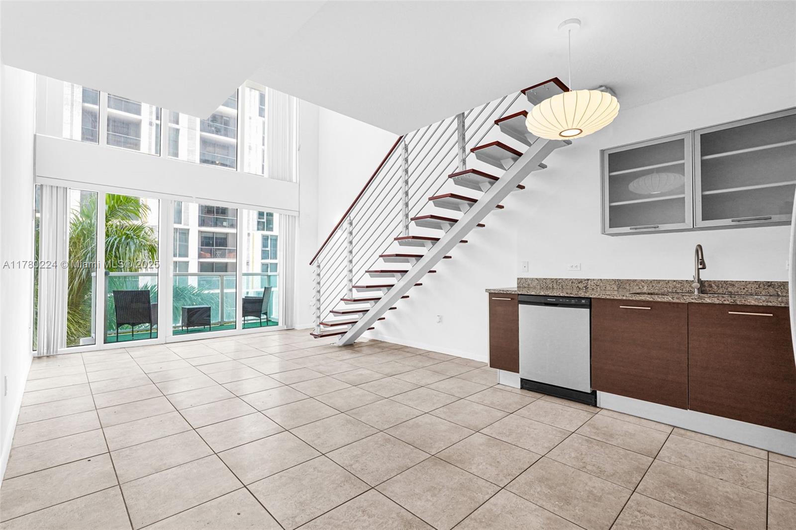 41 Southeast 5th Street, Unit 406 Miami, FL 33131 - Photo 12 of 68 a view of a kitchen with granite countertop a sink and a stove