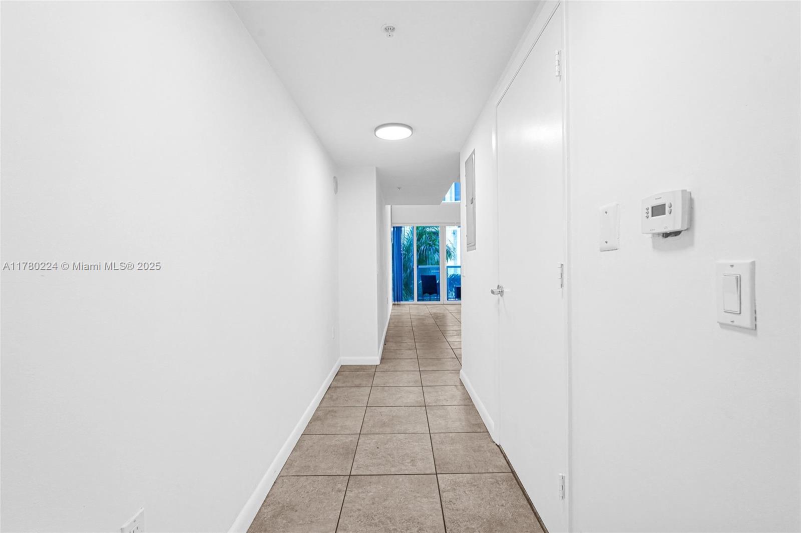 41 Southeast 5th Street, Unit 406 Miami, FL 33131 - Photo 14 of 68 a view of a hallway with wooden floor