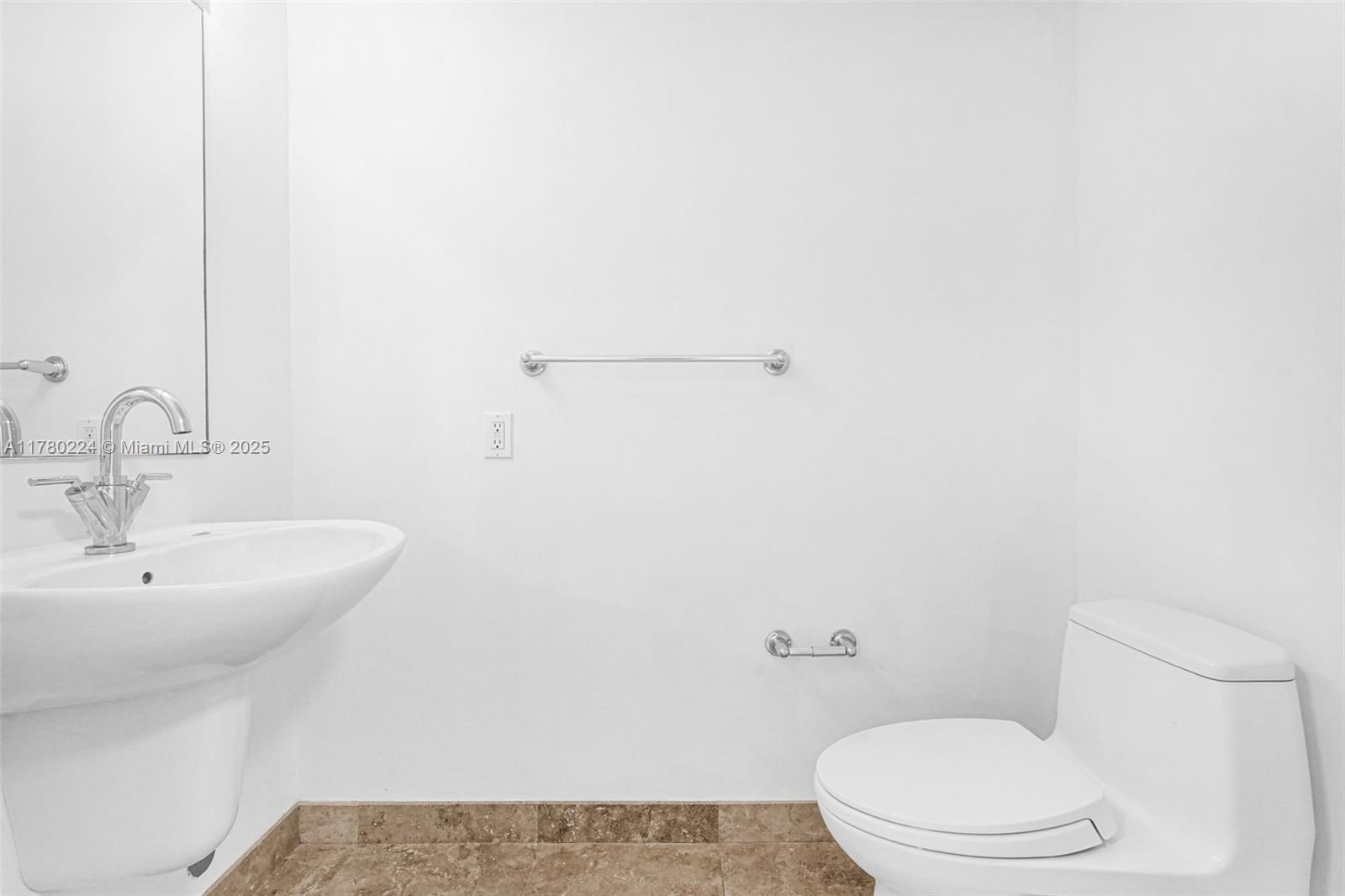 41 Southeast 5th Street, Unit 406 Miami, FL 33131 - Photo 18 of 68 a bathroom with a toilet a sink and mirror