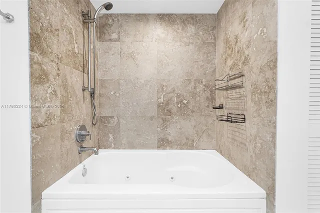 a bathroom with a granite countertop sink a toilet a mirror and vanity