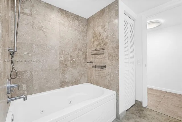 a bathroom with a granite countertop sink a toilet and bathtub