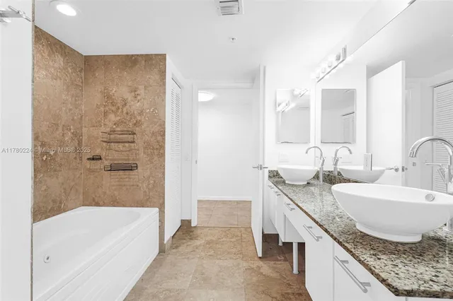 a bathroom with a bathtub and a shower