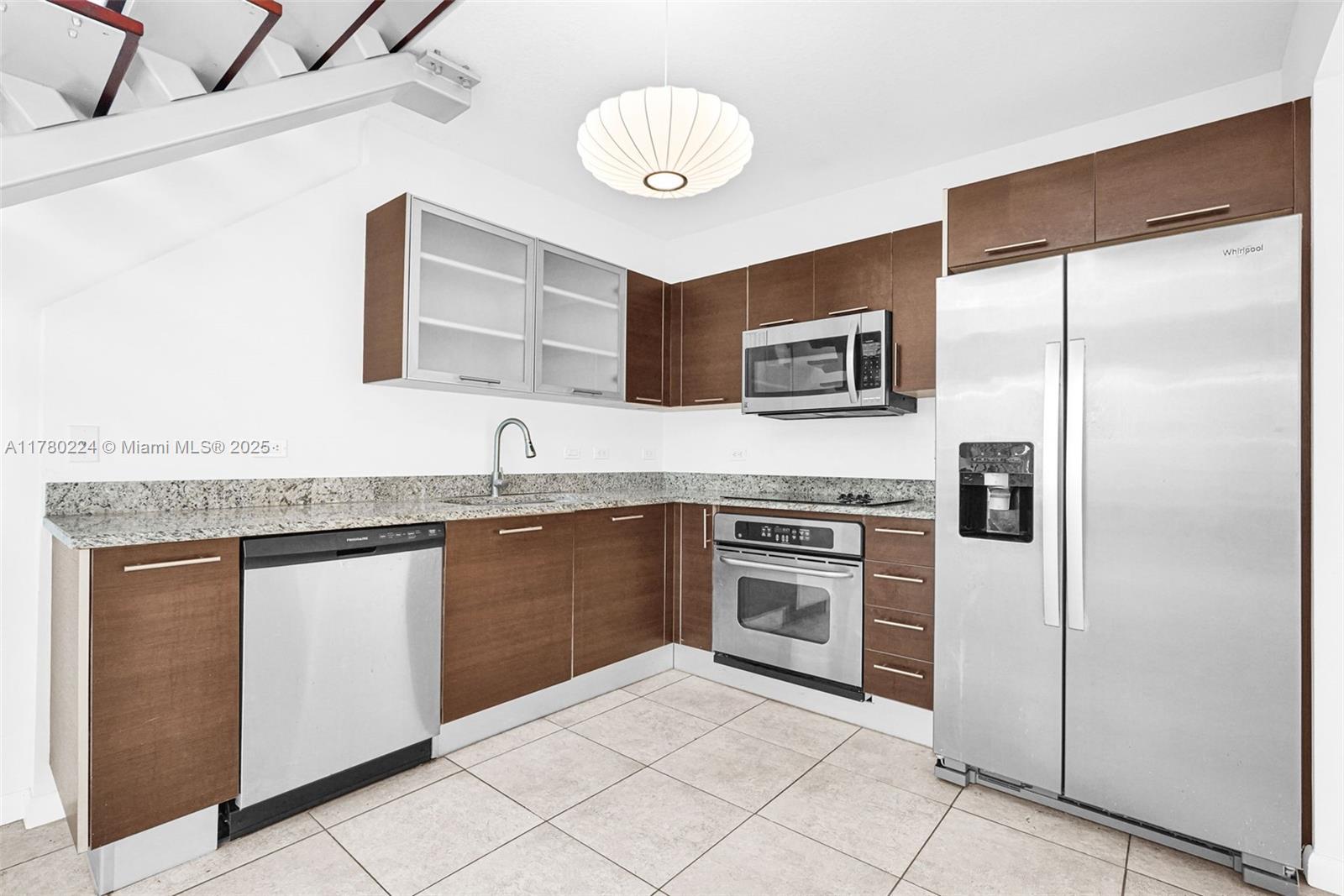 41 Southeast 5th Street, Unit 406 Miami, FL 33131 - Photo 9 of 68 a kitchen with stainless steel appliances granite countertop a refrigerator sink and stove
