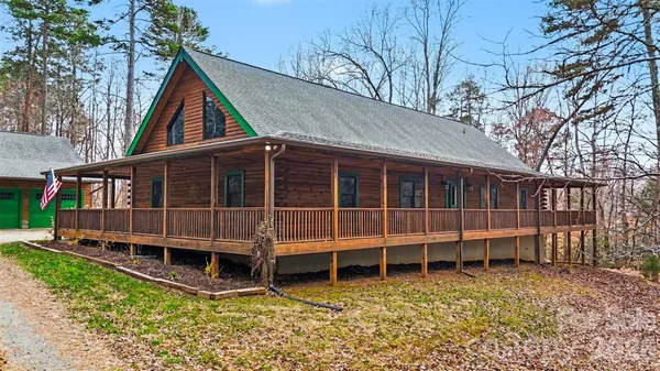a view of a house with a yard and sitting area