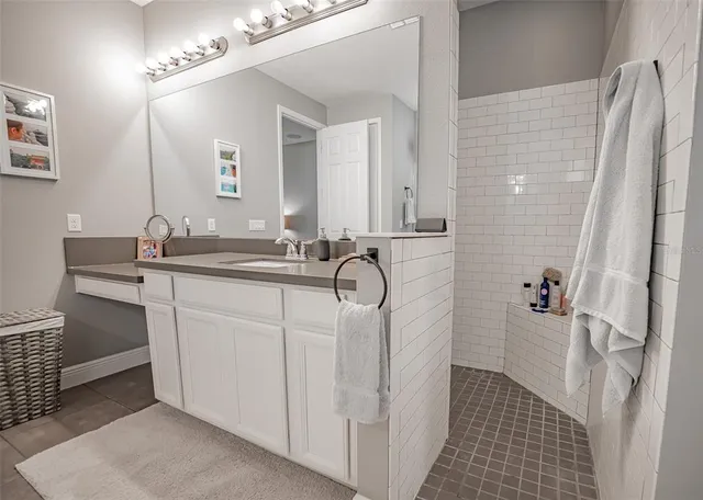 a bathroom with a double vanity sink a mirror and a shower