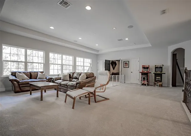 a living room with furniture and a dresser