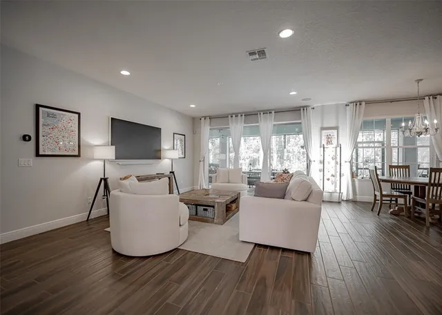 a kitchen with stainless steel appliances kitchen island granite countertop a dining table chairs and sink