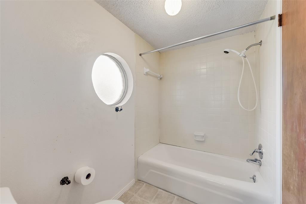 102 South Royal Oak Drive Duncanville, TX 75116 - Photo 13 of 19 a bathroom with a tub and a shower