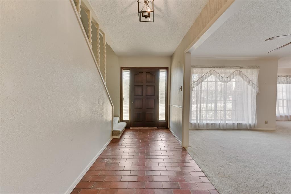 102 South Royal Oak Drive Duncanville, TX 75116 - Photo 3 of 19 a view of a hallway with wooden floor and windows