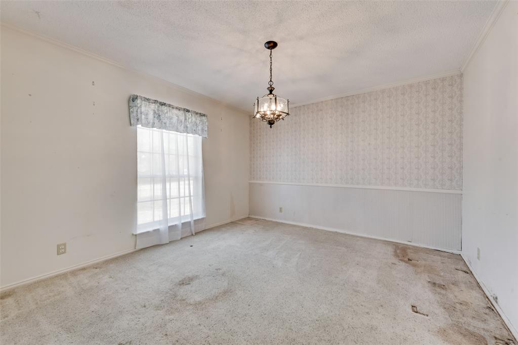 102 South Royal Oak Drive Duncanville, TX 75116 - Photo 6 of 19 an empty room with windows and chandelier fan