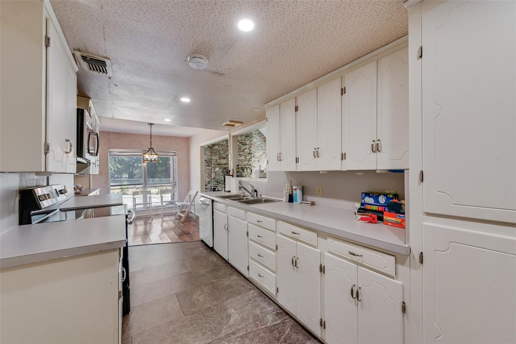102 South Royal Oak Drive Duncanville, TX 75116 - Photo 10 of 19 a kitchen that has a lot of cabinets in it and appliances