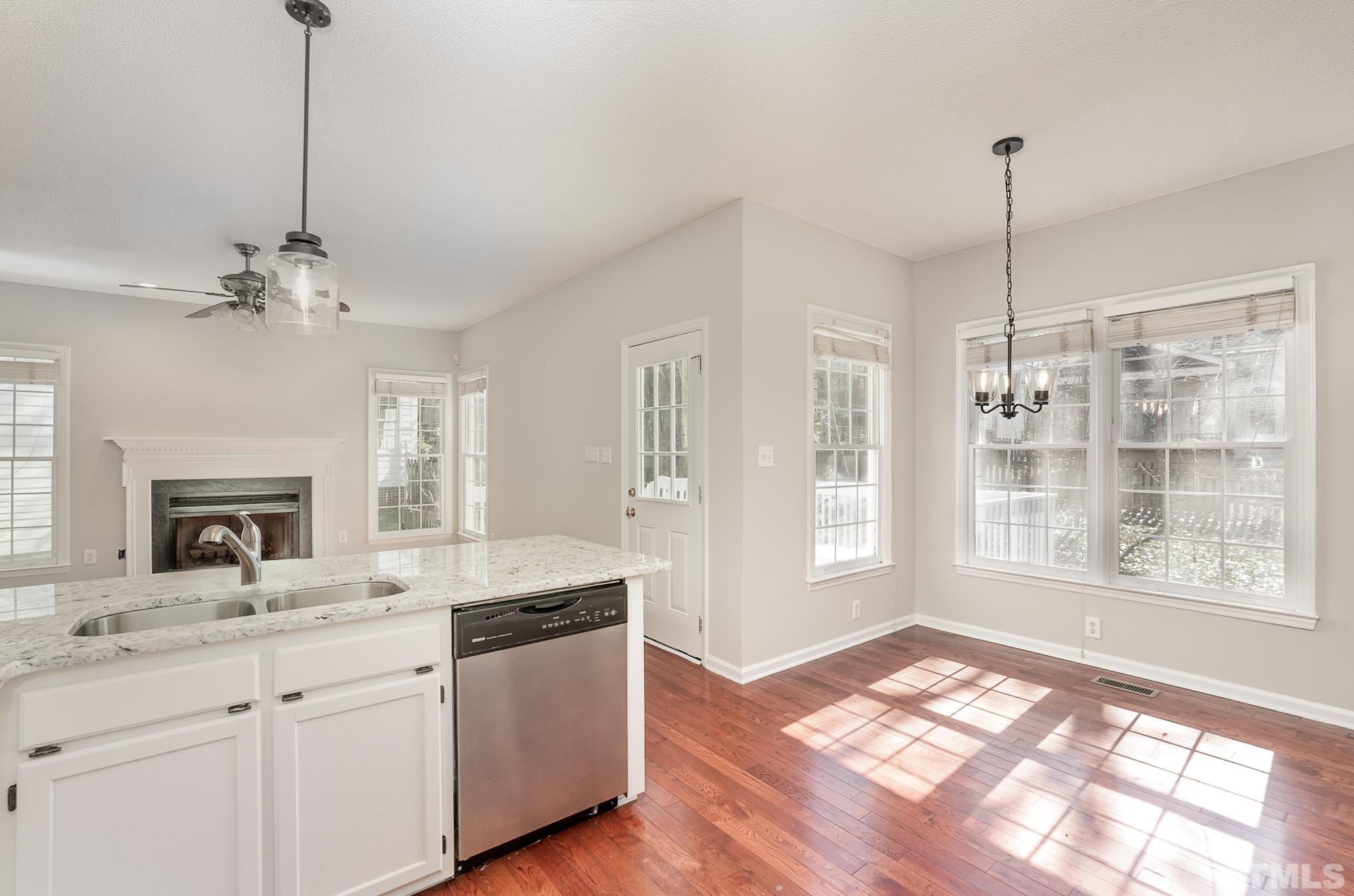 5209 Halcott Court Raleigh, NC 27613 - Photo 11 of 25 a open kitchen with a sink stove and wooden floor