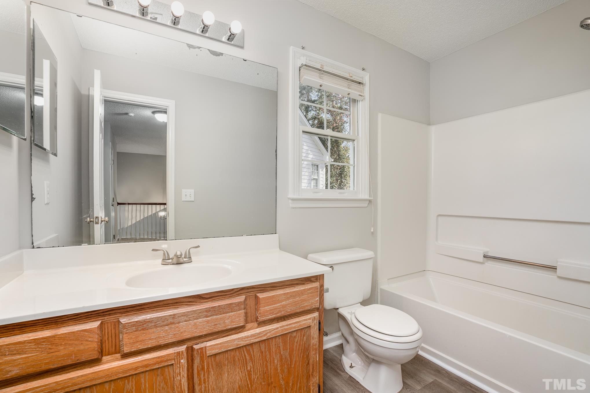 5209 Halcott Court Raleigh, NC 27613 - Photo 20 of 25 a bathroom with a sink toilet and shower