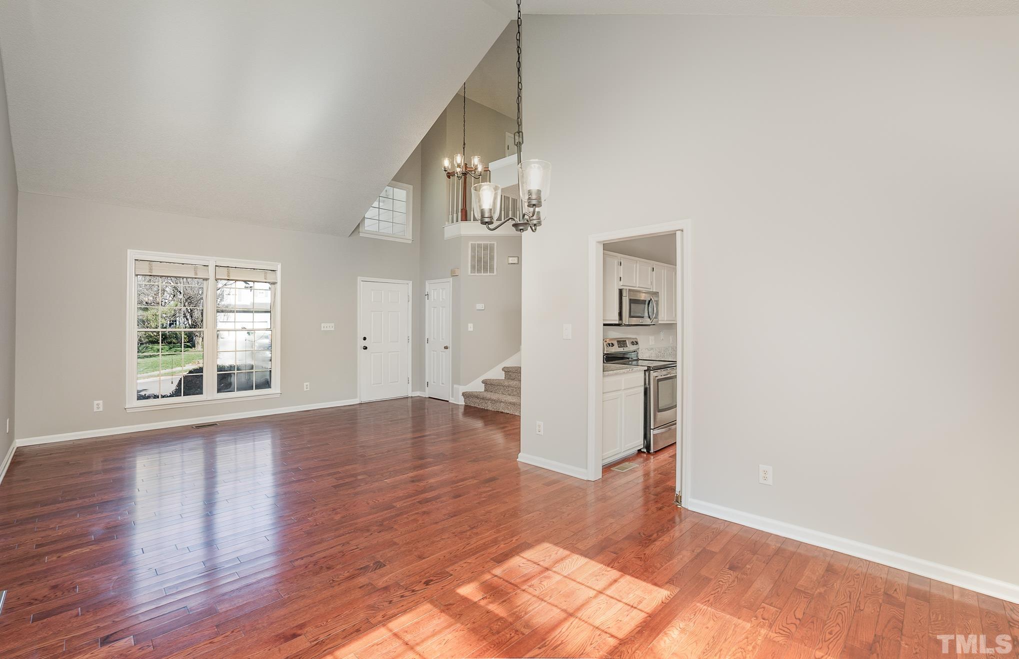 5209 Halcott Court Raleigh, NC 27613 - Photo 6 of 25 a view of an empty room with wooden floor and a window