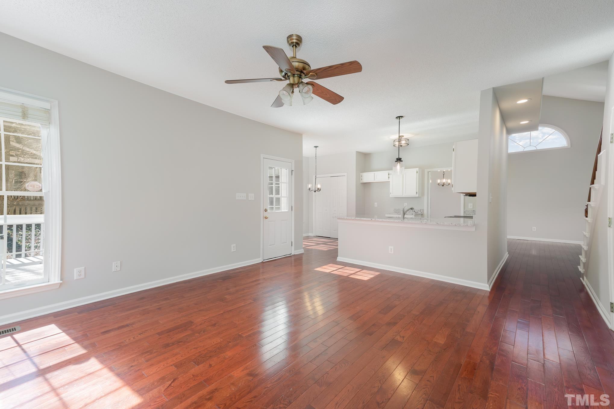 5209 Halcott Court Raleigh, NC 27613 - Photo 8 of 25 a view of a big room with wooden floor and windows