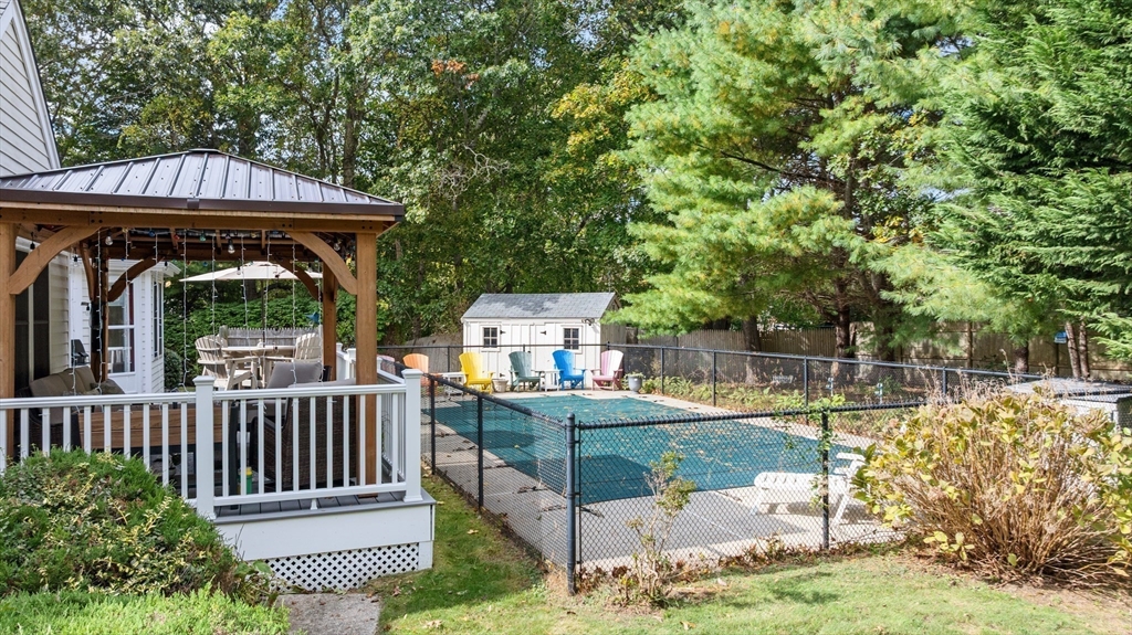 4 Penny Lane Wareham, MA 02558 - Photo 12 of 32 a view of a deck with a table and chairs