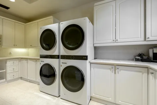 a utility room with sink dryer and washer
