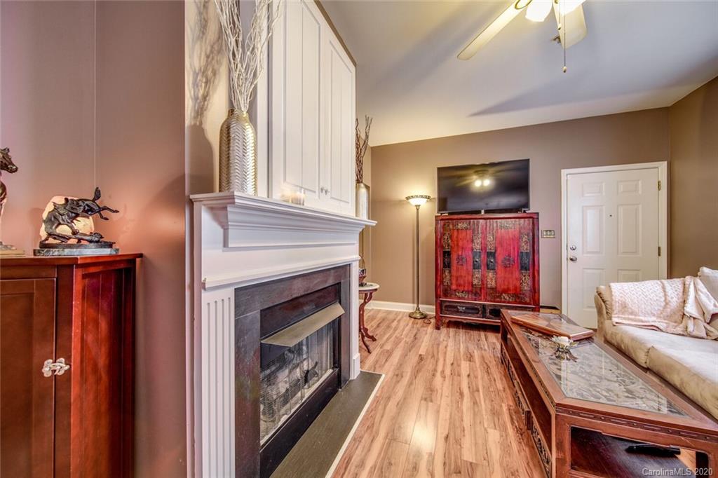 917 Shearer Street, Unit 7 Davidson, NC 28036 - Photo 12 of 31 a living room with furniture a fireplace and a flat screen tv