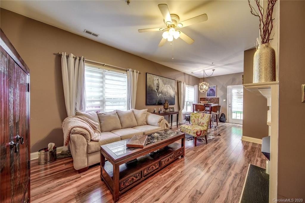 917 Shearer Street, Unit 7 Davidson, NC 28036 - Photo 13 of 31 a living room with furniture a fireplace and a large window