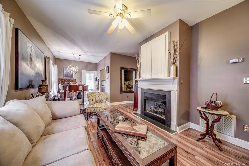 917 Shearer Street, Unit 7 Davidson, NC 28036 - Photo 14 of 31 a living room with furniture a fireplace and a flat screen tv