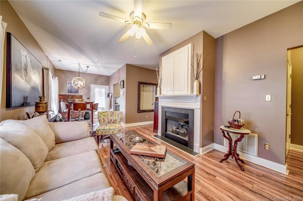917 Shearer Street, Unit 7 Davidson, NC 28036 - Photo 16 of 31 a living room with furniture a fireplace and a flat screen tv
