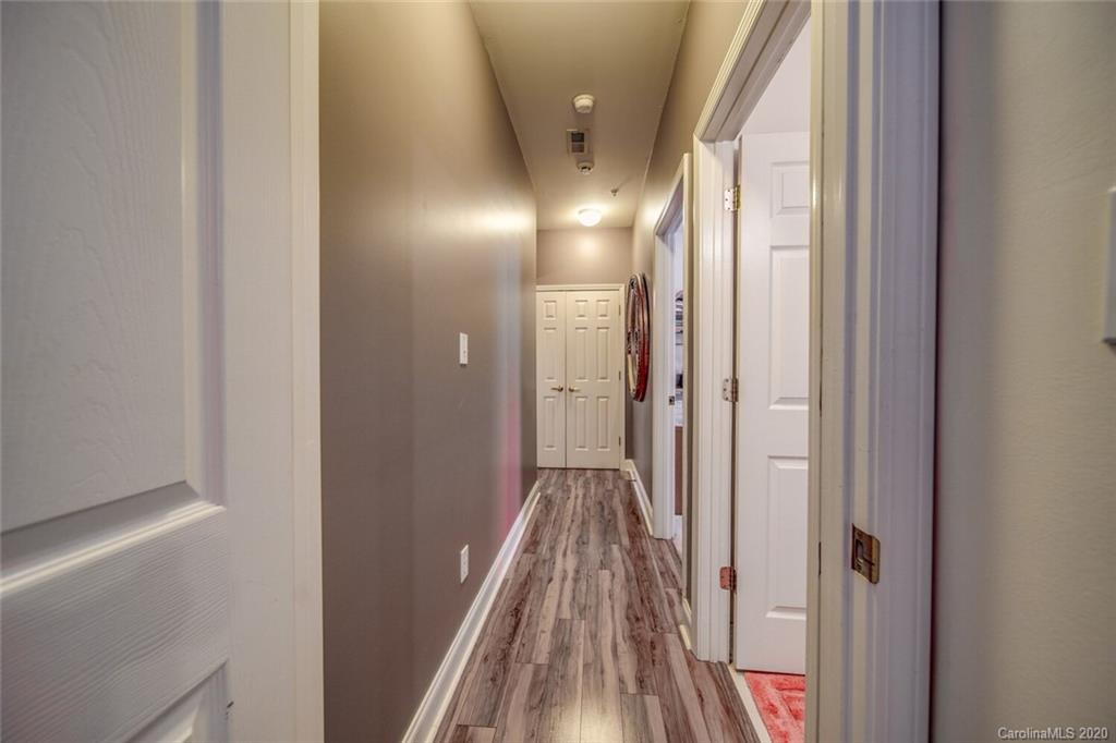917 Shearer Street, Unit 7 Davidson, NC 28036 - Photo 22 of 31 a view of a hallway with wooden floor and a bathroom