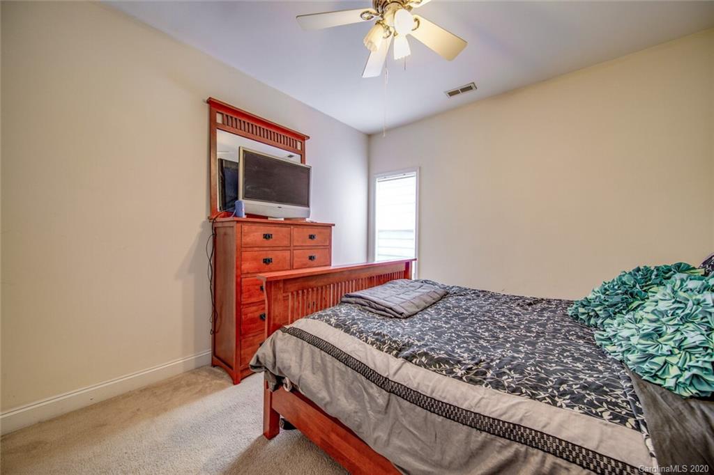 917 Shearer Street, Unit 7 Davidson, NC 28036 - Photo 28 of 31 a bedroom with a bed and a flat screen tv