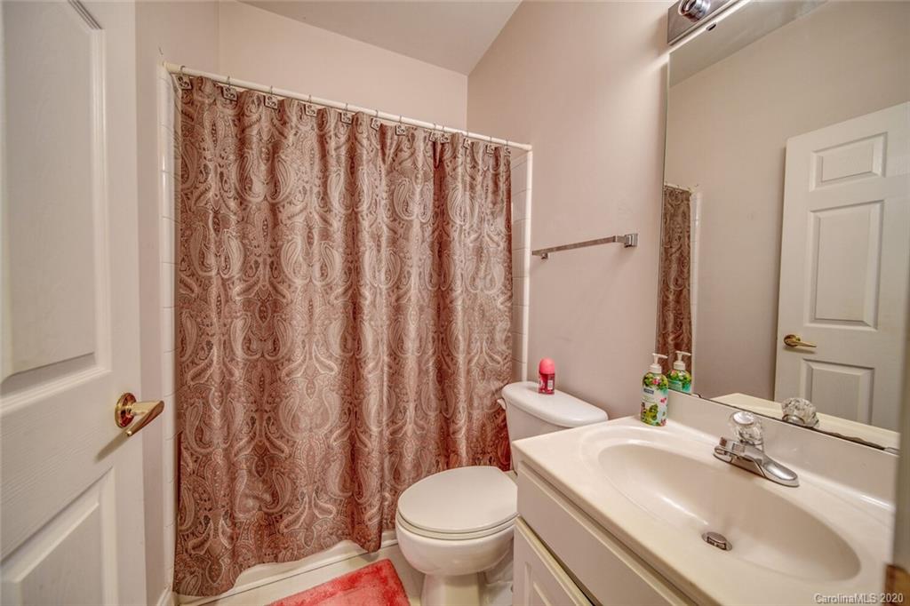 917 Shearer Street, Unit 7 Davidson, NC 28036 - Photo 29 of 31 a bathroom with a toilet a sink and a mirror