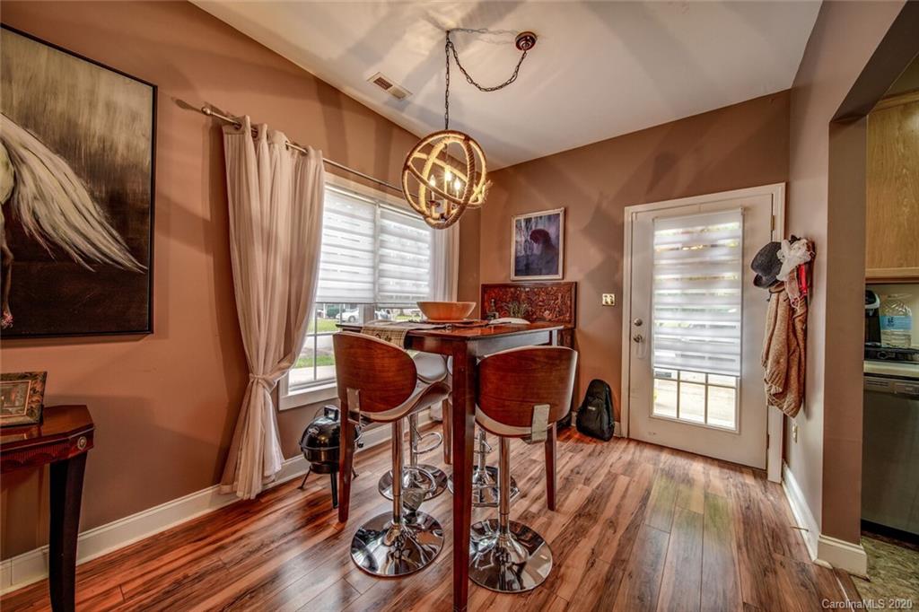 917 Shearer Street, Unit 7 Davidson, NC 28036 - Photo 5 of 31 a view of a dining room with furniture window and wooden floor