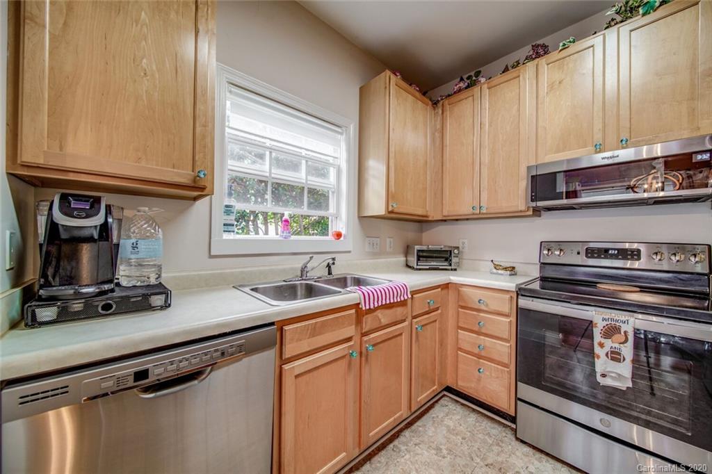 917 Shearer Street, Unit 7 Davidson, NC 28036 - Photo 7 of 31 a kitchen with a sink stove and cabinets