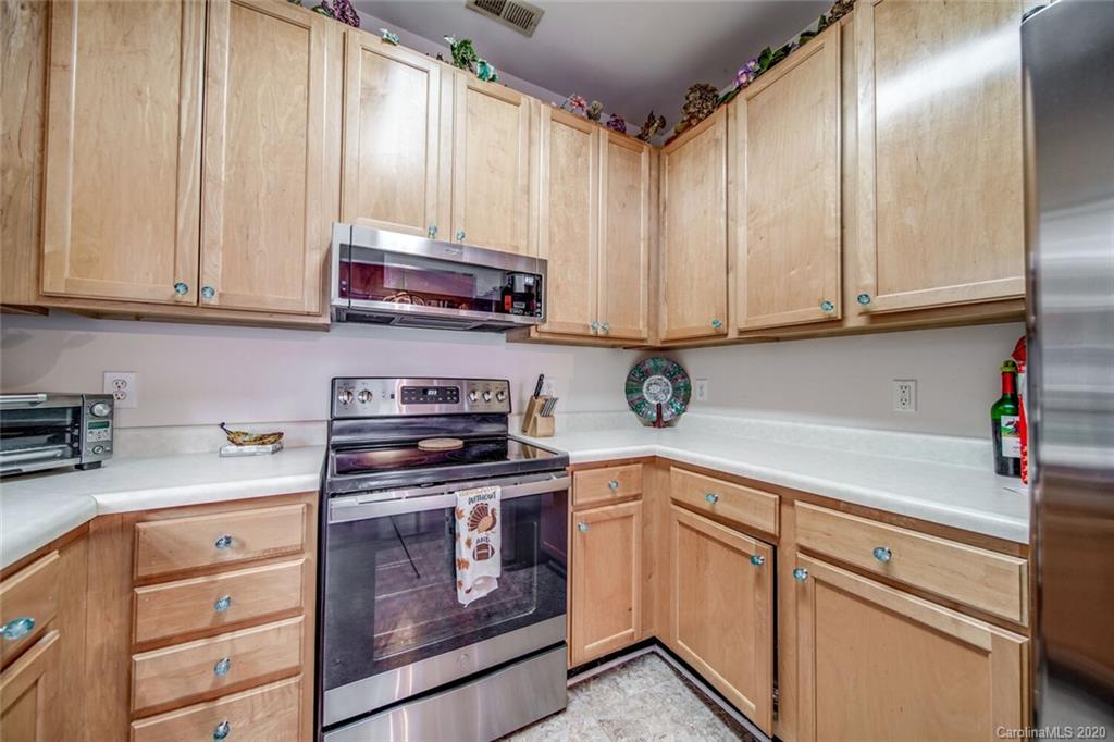 917 Shearer Street, Unit 7 Davidson, NC 28036 - Photo 8 of 31 a kitchen with stainless steel appliances granite countertop a sink a stove and cabinets