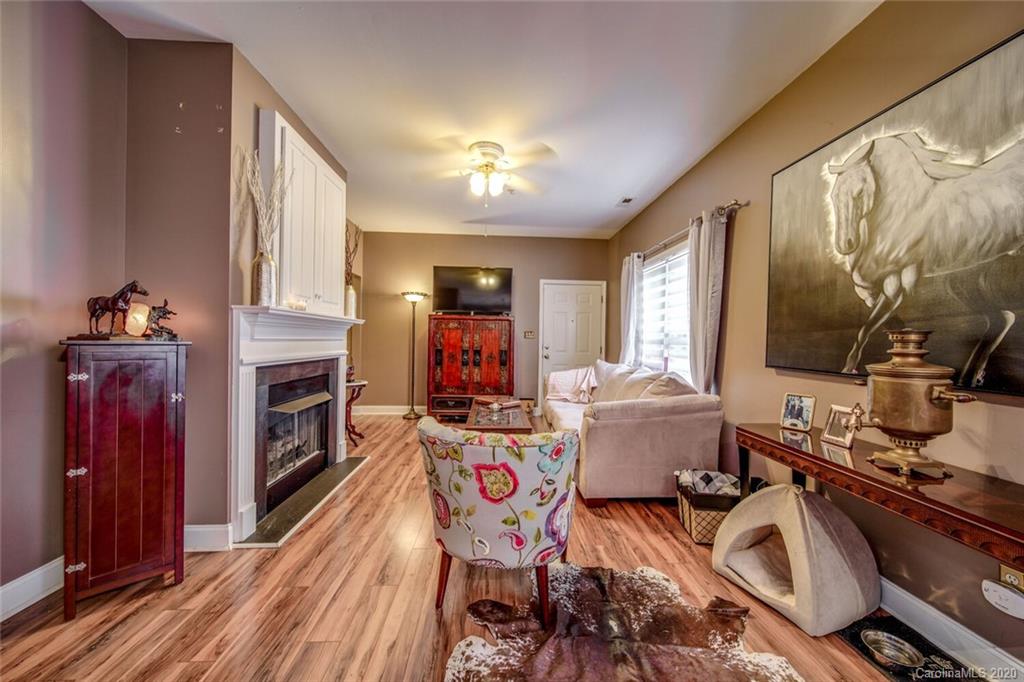 917 Shearer Street, Unit 7 Davidson, NC 28036 - Photo 9 of 31 a living room with furniture and a fireplace