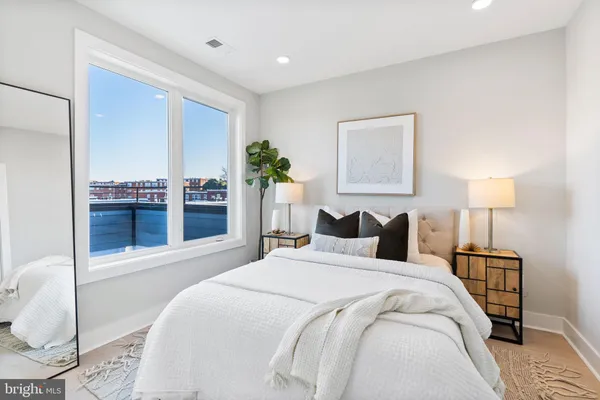 a bedroom with a bed and a lamp on table