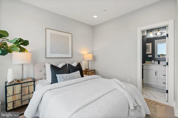 a bedroom with a bed and a lamp on table