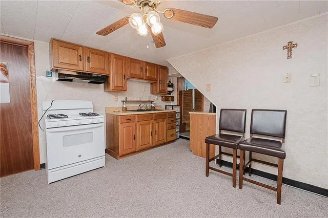 a kitchen with cabinets and chairs