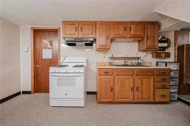 a kitchen with stainless steel appliances granite countertop a sink and cabinets